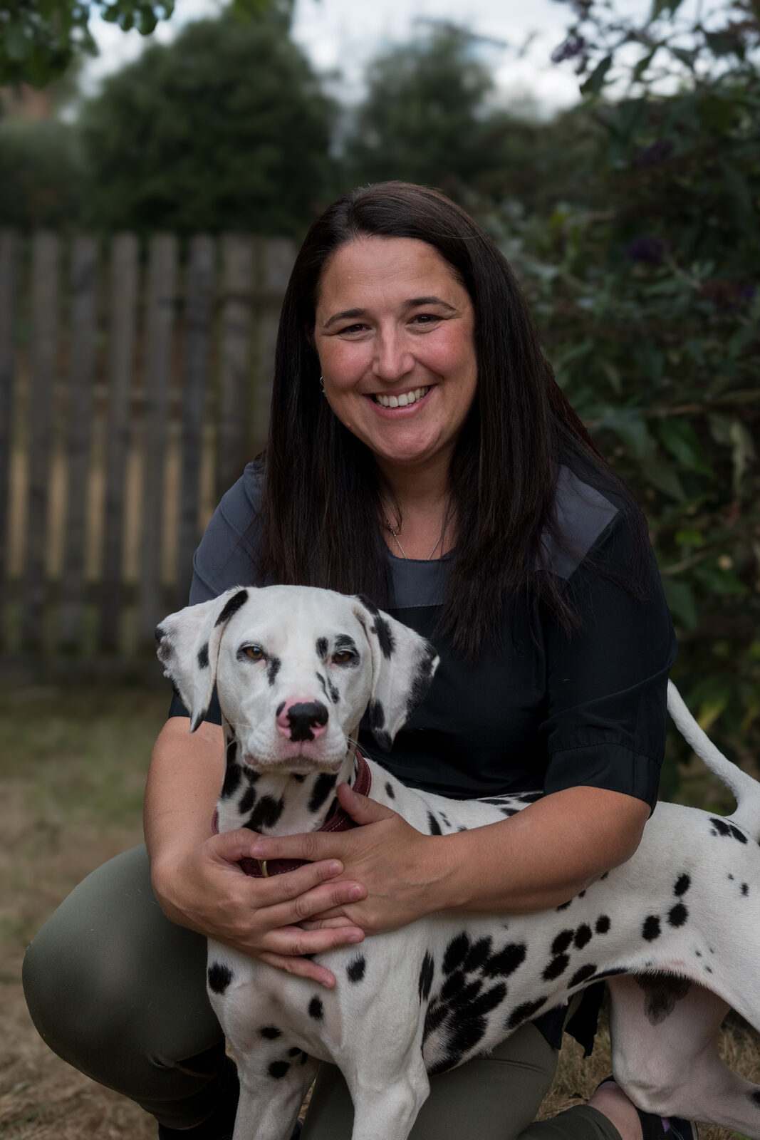 Eda with Rosa, a dalmatian, during a grooming session at Bella Figura