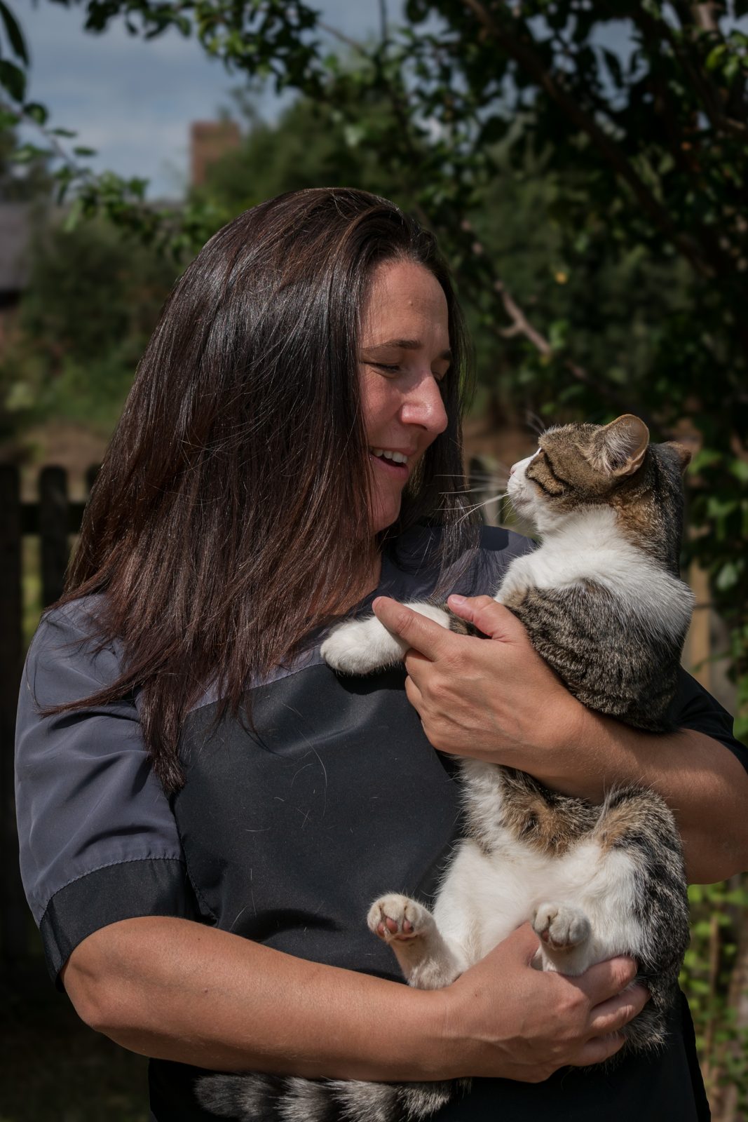 Eda holding a calm cat during a grooming appointment
